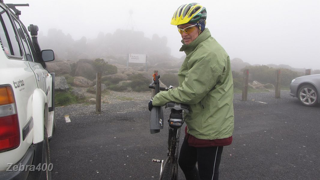 18-Cloud, fog & a very cold wind greets Heidi at the summit of Mt Wellington at 1,271M.JPG